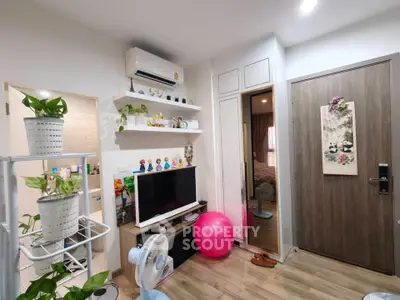 Charming living room with modern decor, wooden flooring, and ample natural light, perfect for cozy living.