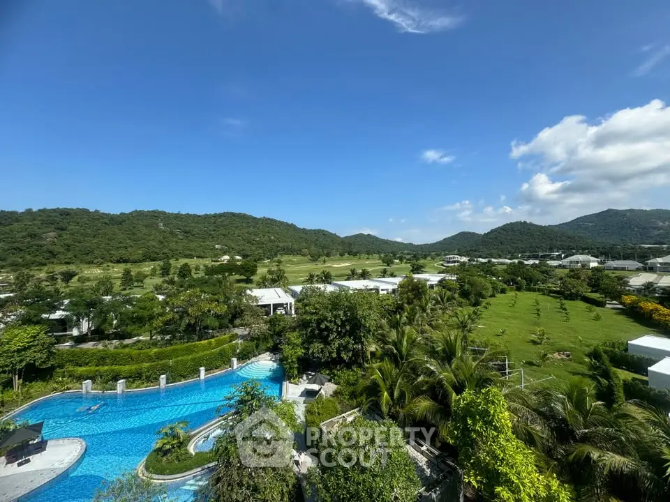 Stunning panoramic view of lush green landscape and luxurious pool area