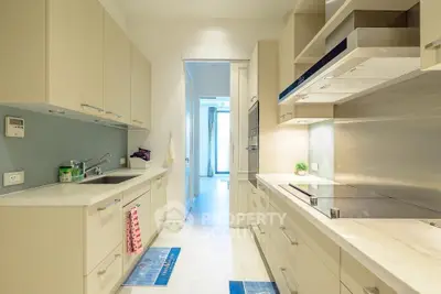 Modern kitchen with sleek cabinetry and integrated appliances in a bright, open layout.