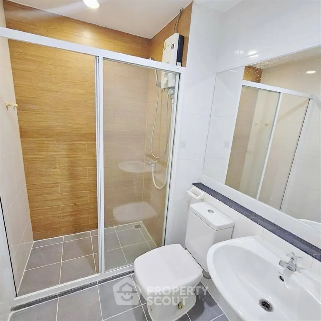 Modern bathroom with glass shower enclosure and sleek fixtures