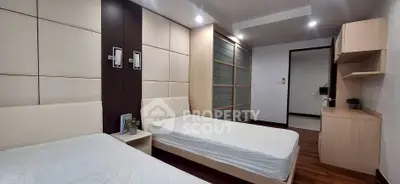 Modern twin bedroom with sleek design and ample storage space