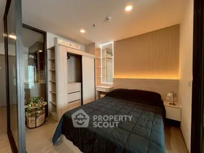 Modern bedroom with sleek design and ambient lighting, featuring a cozy bed and built-in wardrobe.