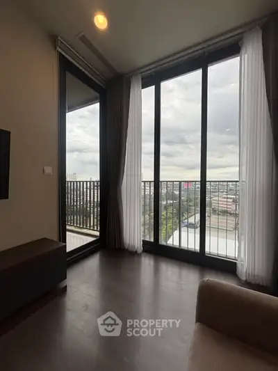 Spacious living room with floor-to-ceiling windows and balcony view