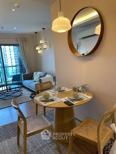 Modern dining area with stylish furniture and city view in a cozy apartment.