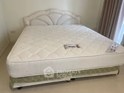 Spacious bedroom with elegant king-size bed and natural light