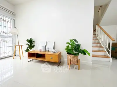 Modern minimalist living room with stylish decor and staircase