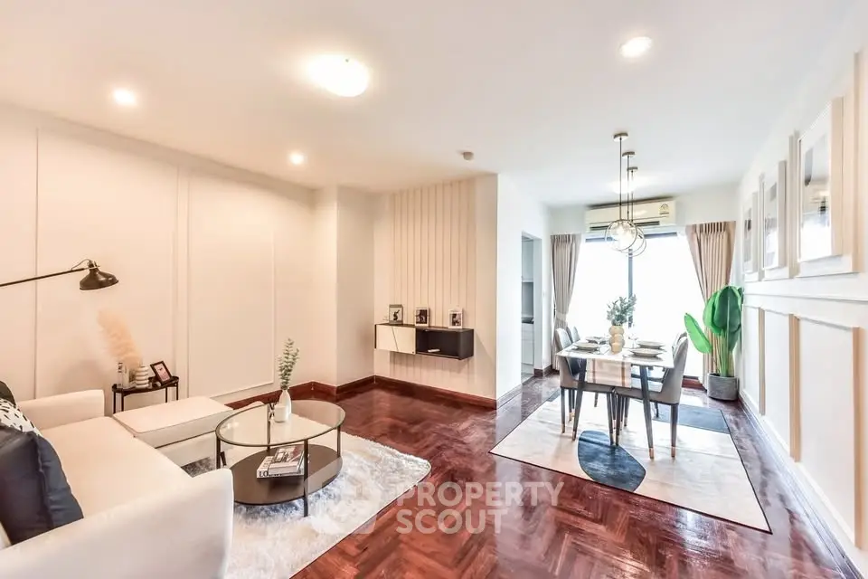 Elegant living and dining area with modern decor and hardwood floors