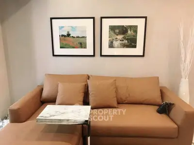 Stylish living room with modern brown sofa and elegant wall art.