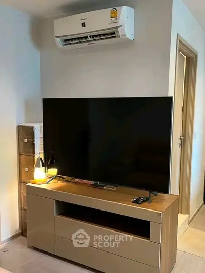 Modern living room with sleek TV unit and air conditioning, perfect for comfortable living.