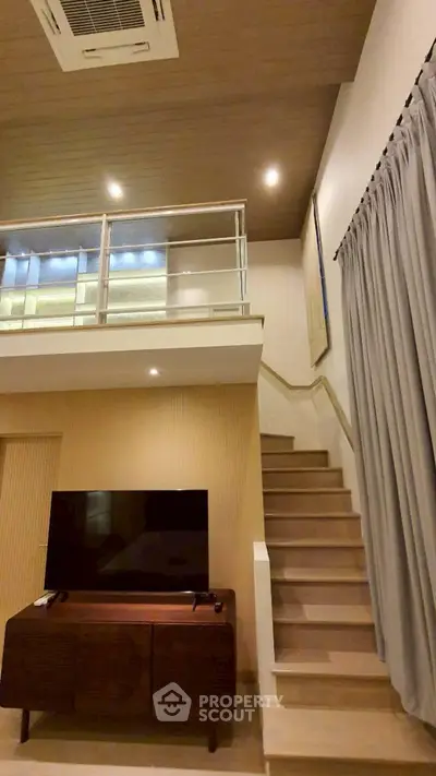 Modern duplex living room with stylish staircase and elegant decor