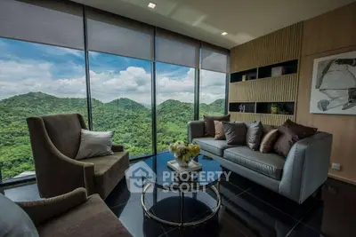 Luxurious living room with panoramic mountain views and elegant modern decor.