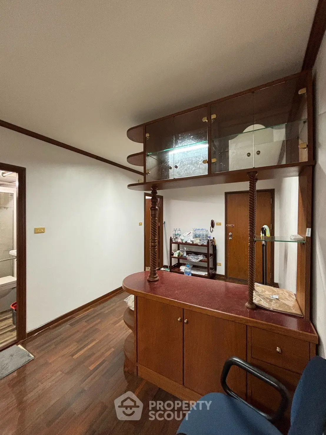 Charming interior with wooden flooring and built-in cabinet, perfect for cozy living.