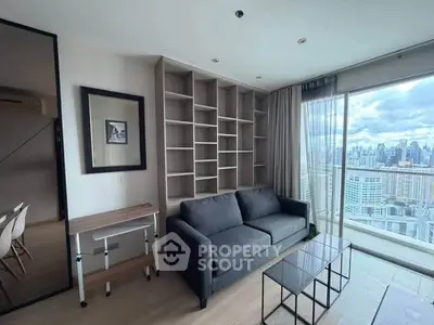 Modern living room with city view, featuring a sleek sofa and built-in shelving.