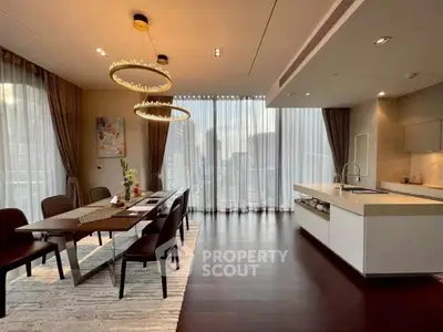 Luxurious dining area with elegant lighting and modern kitchen in high-rise apartment