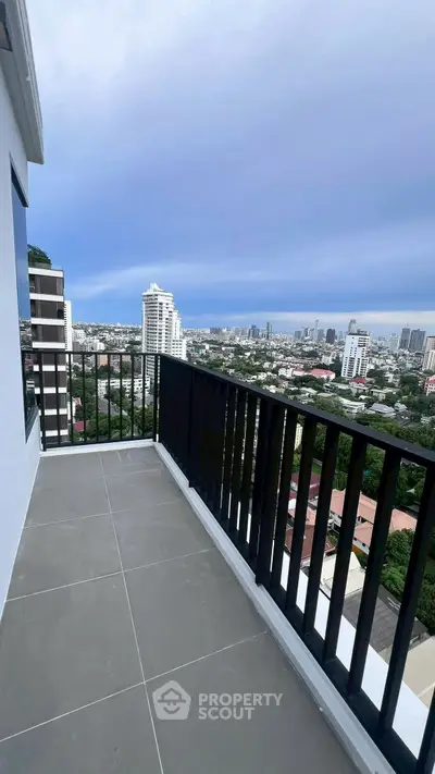 Stunning high-rise balcony with panoramic city views and modern railing design.