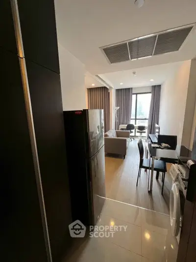 Modern apartment with open layout, featuring kitchen, dining, and living area with city view.