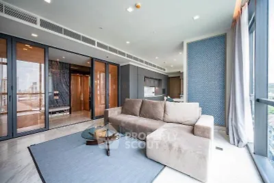 Spacious modern living room with elegant decor and large windows offering city views.