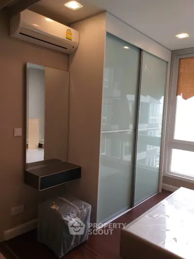 Modern bedroom with air conditioning and large window view