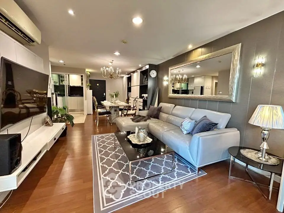 Luxurious living room with elegant decor, spacious seating, and modern lighting in a stylish apartment.