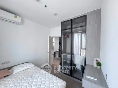 Modern bedroom with sleek design, featuring a built-in wardrobe and minimalist decor.