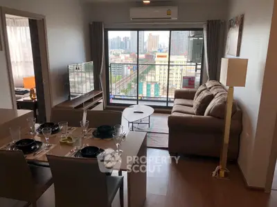 Modern living room with city view, cozy sofa, dining table, and large window.