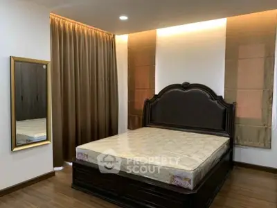 Elegant bedroom with luxurious bed and stylish decor in modern apartment.