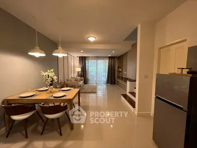Spacious open-plan living and dining area with modern decor and natural light.