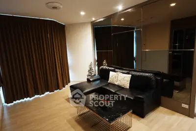 Modern living room with leather sofa and mirrored wall