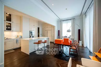Luxurious modern kitchen and dining area with sleek design and high-end finishes.