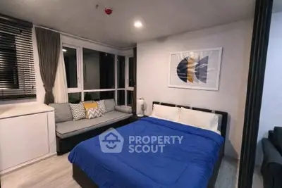 Modern bedroom with stylish decor and cozy seating area, perfect for relaxation.