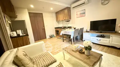 Charming living room with cozy dining area and modern amenities in a stylish apartment.
