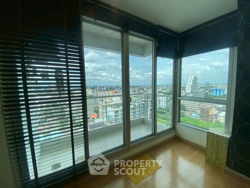 Spacious apartment with stunning city view from large balcony, perfect for urban living.