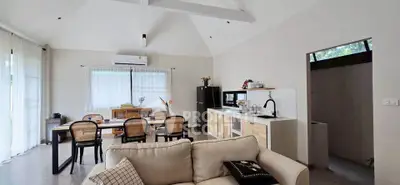 Spacious open-plan living and dining area with modern kitchen in a bright, airy home.