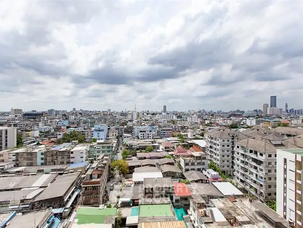 Stunning cityscape view showcasing urban residential buildings under a cloudy sky.