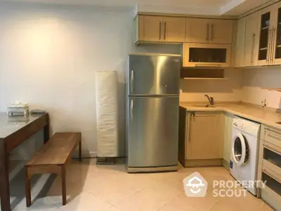 Modern kitchen with stainless steel fridge and washing machine in cozy apartment