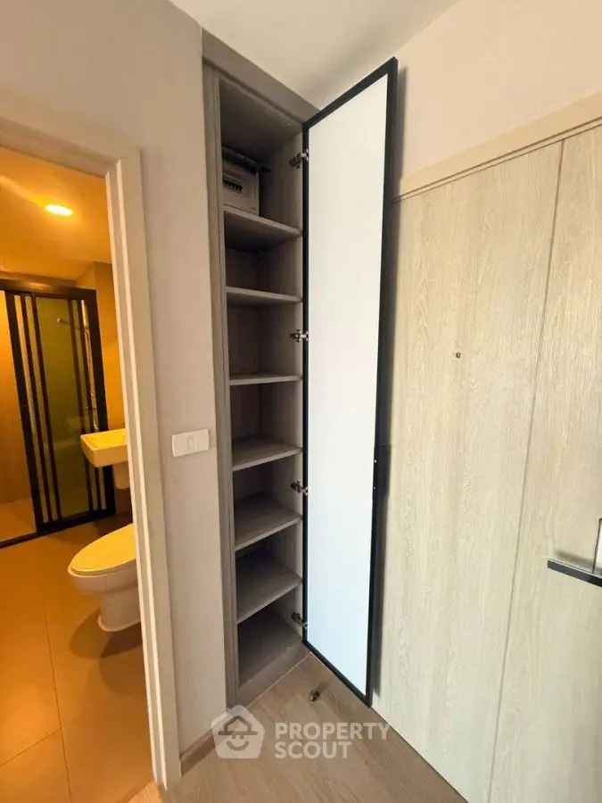 Modern apartment interior with sleek storage and bathroom view