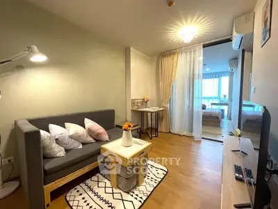 Cozy living room with modern decor and view into bedroom