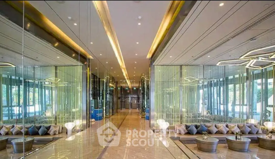 Luxurious modern building entrance with elegant lighting and mirrored walls
