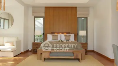Luxurious bedroom with elegant wooden accents and cozy seating area, perfect for relaxation.