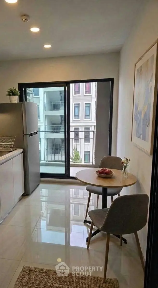 Modern kitchen with dining area and balcony view in stylish apartment