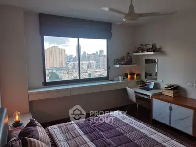 Modern bedroom with city view, stylish decor, and cozy ambiance.
