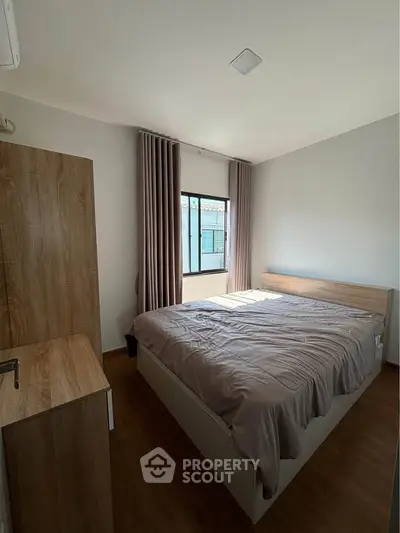 Cozy bedroom with wooden furniture and natural light