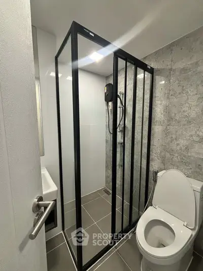 Modern bathroom with sleek shower enclosure and contemporary fixtures.
