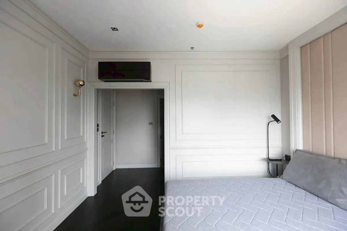 Elegant bedroom with modern paneling and cozy lighting