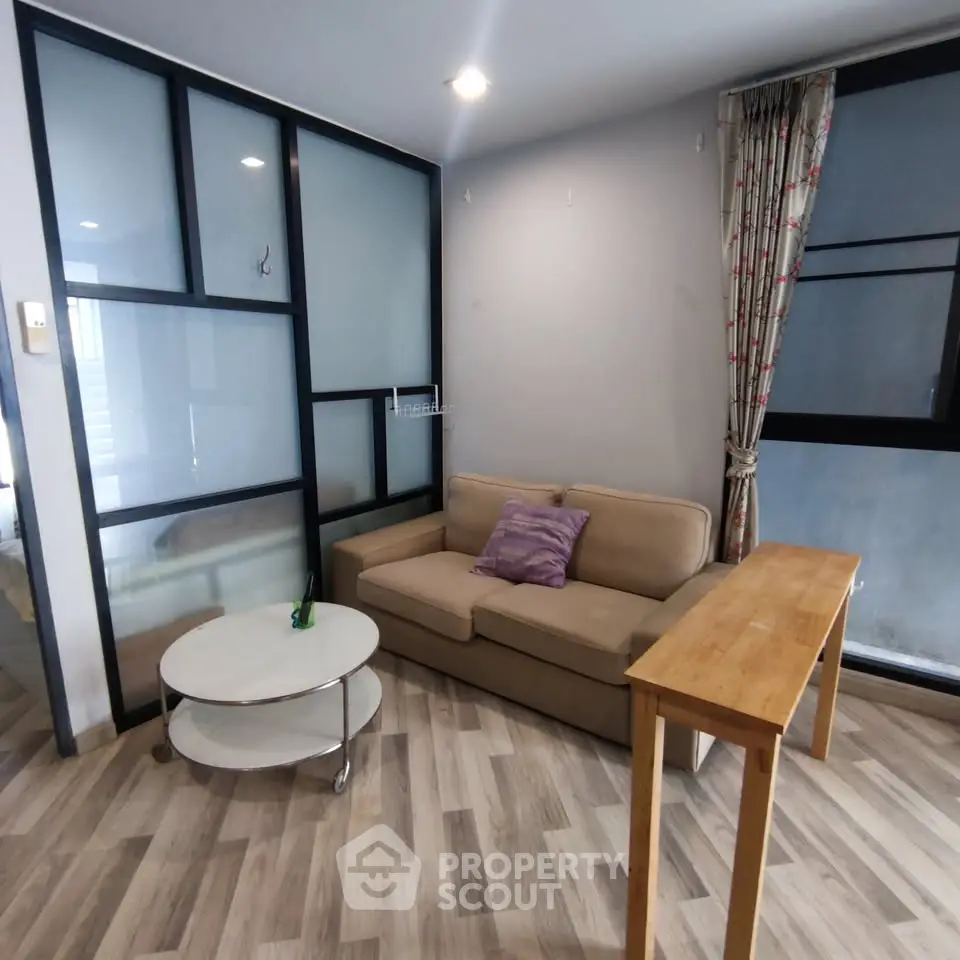 Modern living room with stylish furniture and large windows in a cozy apartment.