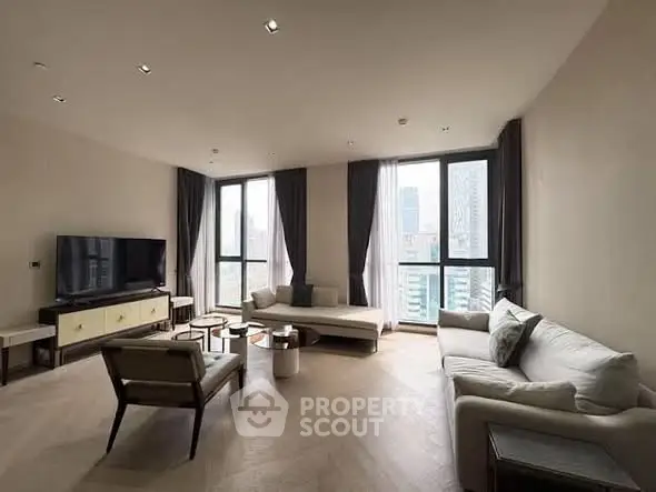 Spacious modern living room with large windows and city view, featuring elegant furniture and neutral tones.