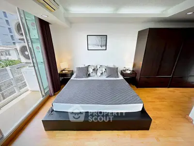 Modern bedroom with large window and stylish decor in urban apartment