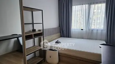Modern minimalist bedroom with natural light and sleek furnishings.