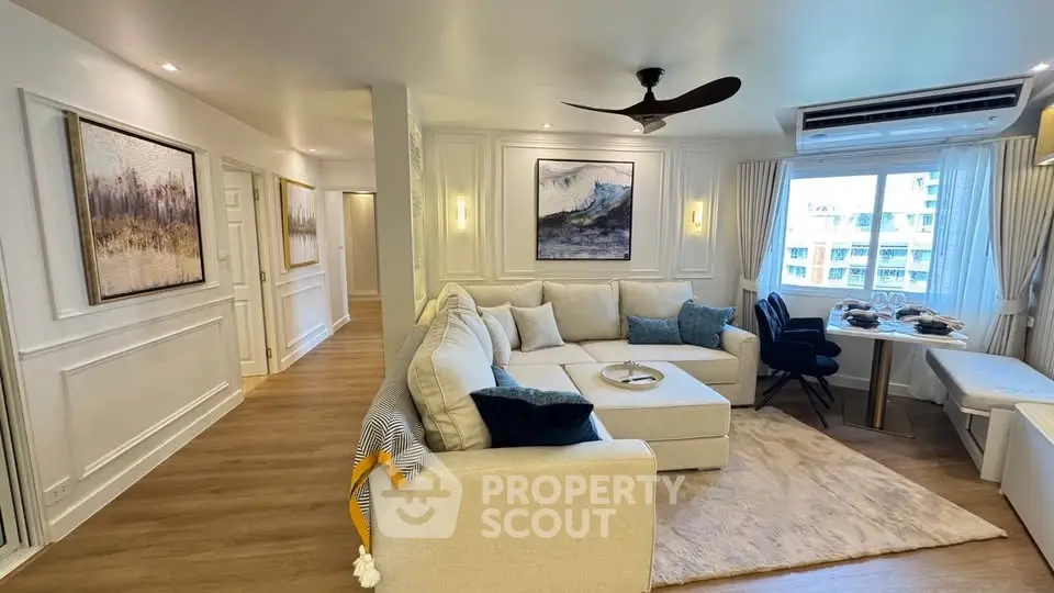 Elegant living room with modern decor and large windows offering natural light.