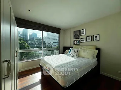 Spacious bedroom with city view and modern decor in urban apartment